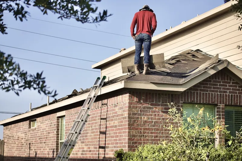 Professional roofer working on a residential roof in Freeport